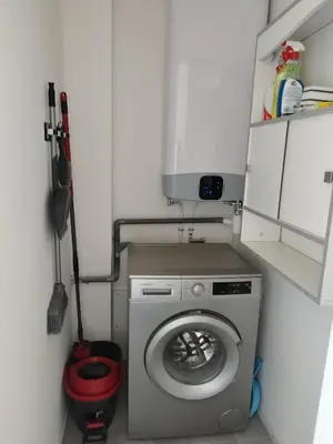 a small bathroom with a washing machine in it at Appartement traversant 2 chambres in Ajaccio