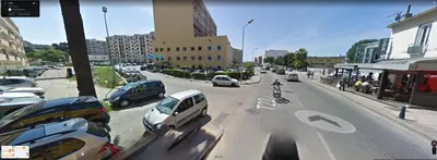 a city street filled with lots of parked cars at Appartement traversant 2 chambres in Ajaccio