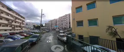 a city street with cars parked in a parking lot at Appartement traversant 2 chambres in Ajaccio