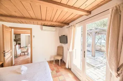 a living room with a door to a patio at Villa Tavara Di Porto-Vecchio in Porto-Vecchio