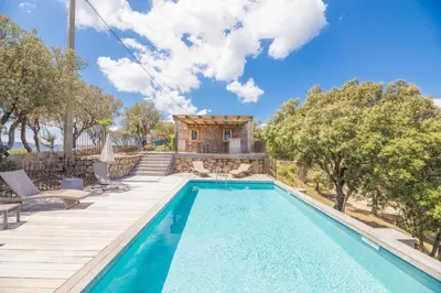 a villa with a swimming pool and a house at Villa Funtanedda Di Porto-Vecchio in Porto-Vecchio
