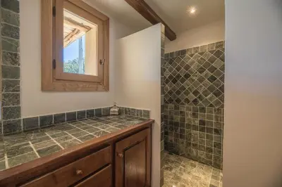 a bathroom with a sink and a shower at Villa Funtanedda Di Porto-Vecchio in Porto-Vecchio