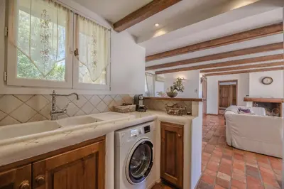 a kitchen with a washing machine and a sink at Villa Funtanedda Di Porto-Vecchio in Porto-Vecchio