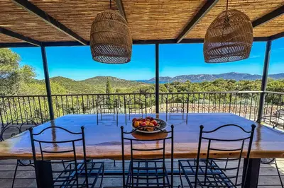 a table with chairs and a bowl of fruit on it at Villa Casteddu Di Porto-Vecchio in Porto-Vecchio