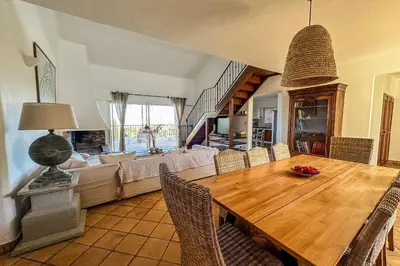 a dining room with a wooden table and chairs at Villa Casteddu Di Porto-Vecchio in Porto-Vecchio
