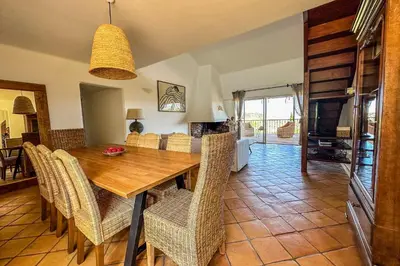 a dining room with a wooden table and chairs at Villa Casteddu Di Porto-Vecchio in Porto-Vecchio