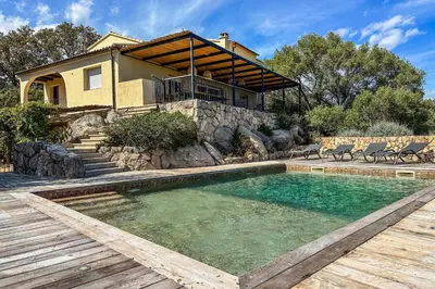 a swimming pool in front of a house at Villa Casteddu Di Porto-Vecchio in Porto-Vecchio