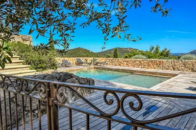 a swimming pool on a balcony with a fence at Villa Casteddu Di Porto-Vecchio in Porto-Vecchio