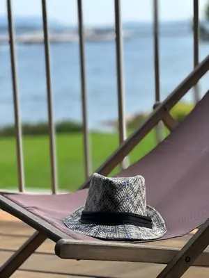 a hat is sitting on a slide at Les oliviers 6 - Appartement pieds dans l'eau in Porto-Vecchio