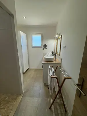 a bathroom with a sink and a mirror at Résidence Patios di Pruno in Figari