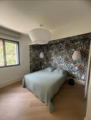 a bedroom with a bed and a wall with a mural at T4 standing a Cargese in Cargèse