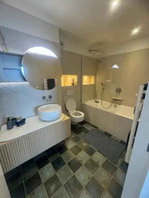 a bathroom with a sink and a tub and a toilet at T4 standing a Cargese in Cargèse