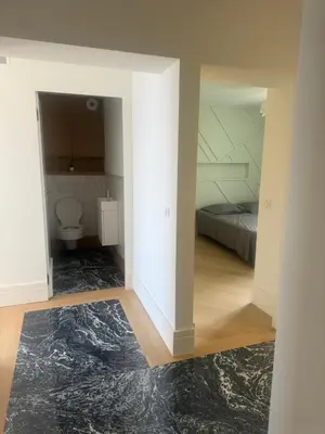 a room with a bedroom with a bed and a toilet at T4 standing a Cargese in Cargèse