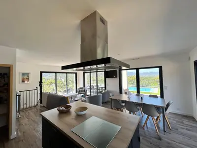 a kitchen and living room with a table and chairs at Casacilagna in Zonza