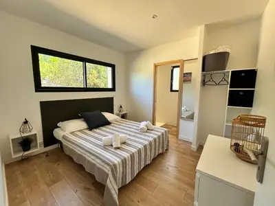 a bedroom with a bed with two towels on it at Casacilagna in Zonza