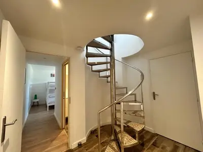 a spiral staircase in a room with a hallway at Casacilagna in Zonza