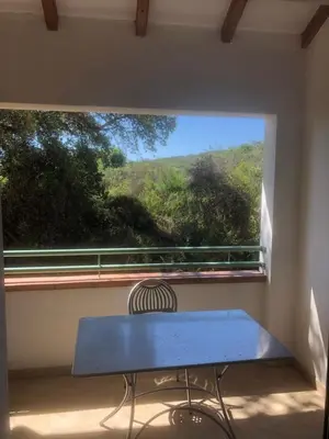 a blue bench sitting in front of a window at Bravone in Linguizzetta