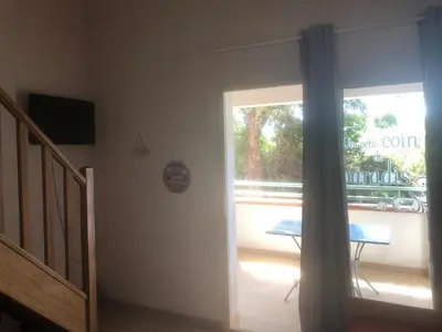 a room with a door open to a patio with a table at Bravone in Linguizzetta