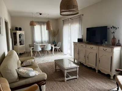 a living room with a couch and a tv at A SUARELLA - Villa climatisée - 4 chambres - piscine chauffée in Sainte-Lucie de Porto-Vecchio