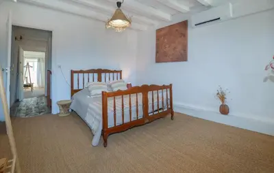 a bedroom with a wooden bed in a room at Cozy Home In Sollacaro With Wifi in Sollacaro