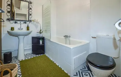 a bathroom with a tub and a toilet and a sink at Cozy Home In Sollacaro With Wifi in Sollacaro