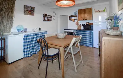 a kitchen with a wooden table and a small table and chairs at Cozy Home In Sollacaro With Wifi in Sollacaro