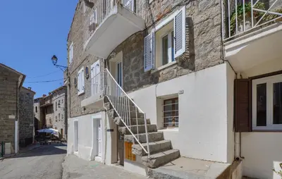 a building with stairs on the side of a street at Cozy Home In Sollacaro With Wifi in Sollacaro