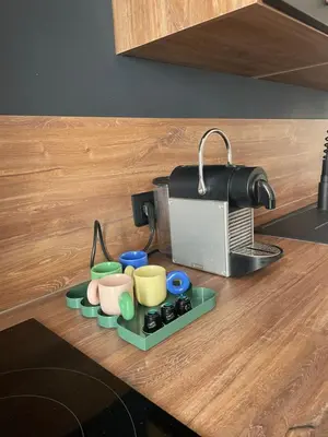 a kitchen counter with a tray of cups and a toaster at Superbe appartement 2 chambres plein centre in Ajaccio