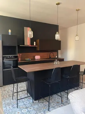 a kitchen with a large wooden table and chairs at Superbe appartement 2 chambres plein centre in Ajaccio