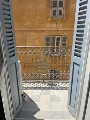 an open door to a balcony with a building at Superbe appartement 2 chambres plein centre in Ajaccio