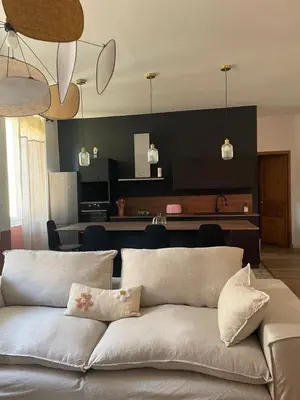 a couch in a living room with a black wall at Superbe appartement 2 chambres plein centre in Ajaccio
