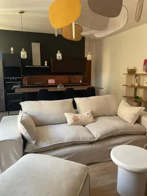 a living room with a couch and a table at Superbe appartement 2 chambres plein centre in Ajaccio