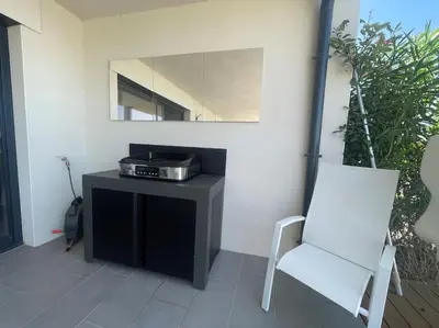 a room with a table with a mirror and a white chair at Villa Pietrosella, vue sur la baie d'Ajaccio in Agnarelu