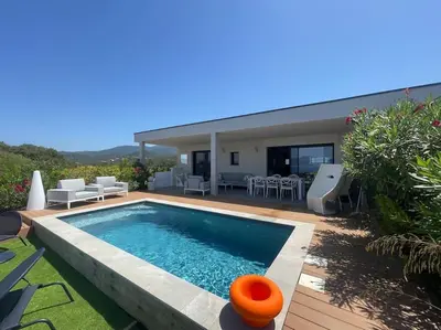 a swimming pool in the backyard of a house at Villa Pietrosella, vue sur la baie d'Ajaccio in Agnarelu