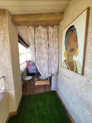 a living room with a couch and a tv at Comme à la maison in Sarrola-Carcopino