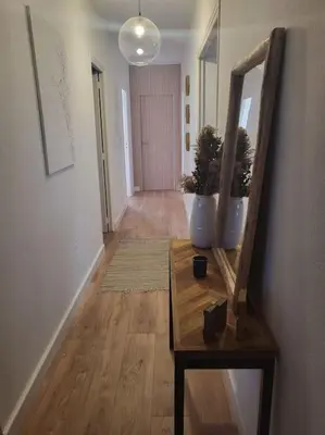 a wooden table and chairs in a living room at Comme à la maison in Sarrola-Carcopino