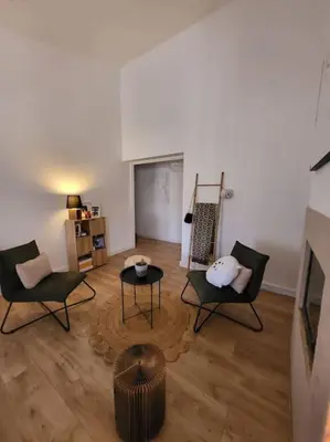 a living room with two chairs and a table at Comme à la maison in Sarrola-Carcopino