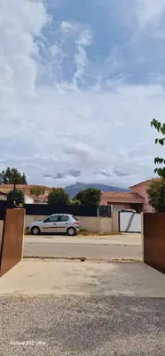 a car parked in a parking lot next to a ramp at Maison Vacance Proche De Calvi in Calenzana
