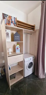 a small laundry room with a washer and dryer at Maison Vacance Proche De Calvi in Calenzana