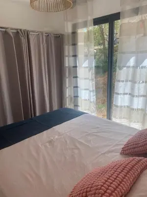 a balcony with a couch and a table and chairs at Corse - Maison face à la mer in Serra-di-Ferro