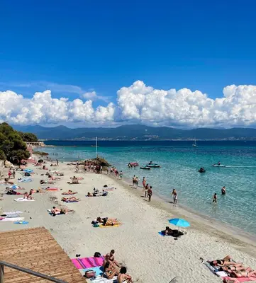 a group of people on a beach in the water at VUE EXCEPTIONNELLE - Ajaccio T3 rte Sanguinaires - Santa Lina in Ajaccio