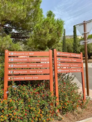 a wooden bench sitting next to a bunch of flowers at VUE EXCEPTIONNELLE - Ajaccio T3 rte Sanguinaires - Santa Lina in Ajaccio