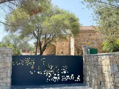 a blue fence with gold butterflies on it at Villa NAOMI piscine à 100 m de la plage in Olmeto
