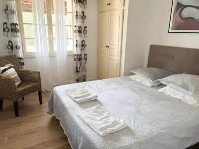 a bedroom with a bed with two towels on it at Villa NAOMI piscine à 100 m de la plage in Olmeto