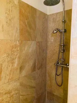 a shower with a shower head in a bathroom at Studio équipé vue mer in Propriano