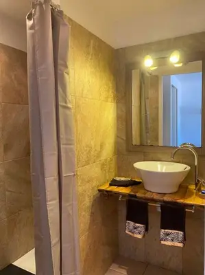 a bathroom with a sink and a mirror at Studio équipé vue mer in Propriano