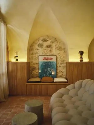 a room with a stone wall with a movie sign at Ajaccio Hypercentre, Superbe appartement dans une ancienne écurie du XVIIIe Siècle in Ajaccio