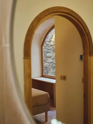 a view of a room with a window and a chair at Ajaccio Hypercentre, Superbe appartement dans une ancienne écurie du XVIIIe Siècle in Ajaccio