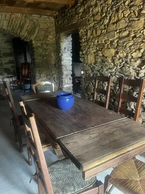 a wooden table with chairs and a blue bowl on it at A Scontra in Moïta