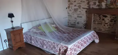 a bedroom with a bed and a wooden night stand at A Scontra in Moïta